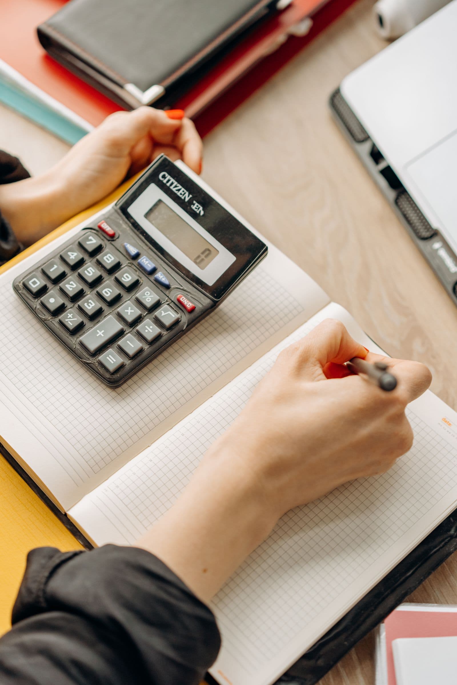 Carnet et calculatrice posés sur un bureau